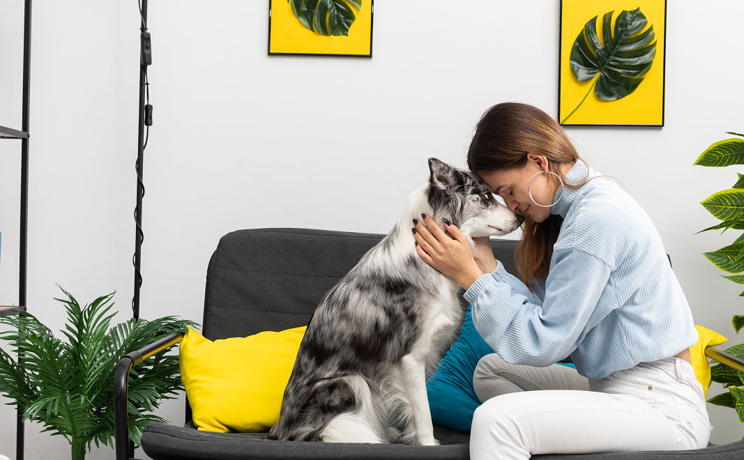 Woman sharing a loving moment with her husky dog
